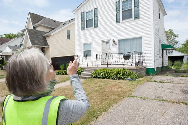 A surveyer takes a photo of a property during the Wayne County canvassing.